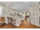 Modern white kitchen with granite countertops, stainless steel appliances, and a breakfast bar at 11415 N Camden Commons Dr, Windermere, FL 34786
