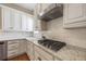 Close-up of the kitchen featuring granite counters, stainless steel appliances, and white cabinetry at 11415 N Camden Commons Dr, Windermere, FL 34786