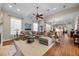 Spacious living area with lots of seating, a fireplace, wood floors, and lots of natural light at 11415 N Camden Commons Dr, Windermere, FL 34786