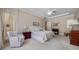 Well-appointed main bedroom with soft decor, comfortable chair, and ample natural light at 11415 N Camden Commons Dr, Windermere, FL 34786