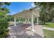 Open air brick pavilion with white pillars and a white roof sits near playground at 11415 N Camden Commons Dr, Windermere, FL 34786