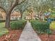 Scenic community playground and play area with manicured landscaping and mature shade trees at 11415 N Camden Commons Dr, Windermere, FL 34786