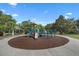 Playground with multiple play stations, swings, and a covered picnic shelter in background at 11415 N Camden Commons Dr, Windermere, FL 34786