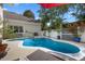 A backyard pool and spa are surrounded by lush landscaping in this backyard oasis at 11415 N Camden Commons Dr, Windermere, FL 34786