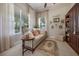 Sitting room with neutral walls, sofa, and large windows at 11415 N Camden Commons Dr, Windermere, FL 34786