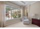 Bright sitting area with a comfortable chair, a large window, and plush carpeting at 11415 N Camden Commons Dr, Windermere, FL 34786