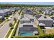 Aerial view of a home featuring a screened pool, solar panels, and a playground in the backyard at 11993 Charades St, Orlando, FL 32832