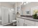 Bright bathroom with white cabinets, a gray countertop, and a glass-enclosed shower, creating a spa-like retreat at 11993 Charades St, Orlando, FL 32832