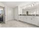 This neutral bathroom features double sinks, white cabinets, and tile floors at 11993 Charades St, Orlando, FL 32832