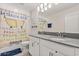 Bright bathroom with dual sinks, white cabinetry, and humorous shower curtain at 11993 Charades St, Orlando, FL 32832