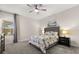 Cozy bedroom with neutral tones, a patterned bedspread, and soft lighting for a relaxing atmosphere at 11993 Charades St, Orlando, FL 32832