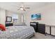 This bedroom features modern furnishings and a wall-mounted television creating a cozy and stylish retreat at 11993 Charades St, Orlando, FL 32832