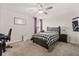 This comfortable bedroom features a ceiling fan and carpeted floors at 11993 Charades St, Orlando, FL 32832