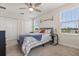Bright bedroom featuring neutral walls, two windows providing ample natural light, and closet for storage at 11993 Charades St, Orlando, FL 32832