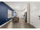 Inviting dining area with a navy accent wall adjacent to kitchen, creating an open and stylish space at 11993 Charades St, Orlando, FL 32832
