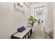 Bright foyer with a bench and storage, leading to a spacious hallway with views of the living area at 11993 Charades St, Orlando, FL 32832