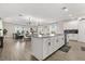 Open-concept kitchen with modern appliances, large island, and seamless flow to the living area at 11993 Charades St, Orlando, FL 32832