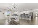 Modern open-concept kitchen and dining area with stylish lighting, stainless steel appliances, and a center island at 11993 Charades St, Orlando, FL 32832