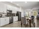 Contemporary kitchen with white cabinetry, stainless steel appliances, and a stylish backsplash for a modern look at 11993 Charades St, Orlando, FL 32832