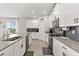 Well-equipped kitchen with stainless steel appliances, gray backsplash, and ample counter space for meal preparation at 11993 Charades St, Orlando, FL 32832