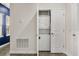 Practical laundry closet with a stacked washer and dryer, efficiently maximizing space with easy access at 11993 Charades St, Orlando, FL 32832