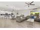Open-concept living and dining area with a modern kitchen in the background at 11993 Charades St, Orlando, FL 32832