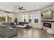 Bright living room with a fireplace, large windows and an open floor plan at 11993 Charades St, Orlando, FL 32832