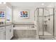 This bright main bathroom features double sinks, a soaking tub, and a glass-enclosed shower at 11993 Charades St, Orlando, FL 32832