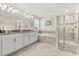 The stylish main bathroom features a large mirror, white cabinets, a soaking tub, and a glass shower at 11993 Charades St, Orlando, FL 32832
