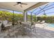 Enclosed patio with pavers, outdoor furniture, and a glimpse of the refreshing pool area at 11993 Charades St, Orlando, FL 32832