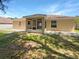 The backyard features a screened-in porch, a well-maintained lawn and ample sunlight at 131 Pecan Pass, Ocala, FL 34472
