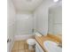 Bathroom features a clean bathtub, tiled floors, white fixtures, a neutral color palette, and vanity with sink at 131 Pecan Pass, Ocala, FL 34472