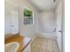 Clean bathroom featuring a bathtub and shower combination, vanity with a large mirror, and tile flooring at 131 Pecan Pass, Ocala, FL 34472