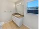 Bathroom featuring a vanity with ample storage, a well-lit mirror, tile floors, and a window providing natural light at 131 Pecan Pass, Ocala, FL 34472