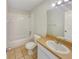Clean bathroom with a tub, neutral tiles, and a vanity sink with mirror at 131 Pecan Pass, Ocala, FL 34472