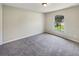 Clean bedroom with neutral tones, plush carpeting, and bright natural light at 131 Pecan Pass, Ocala, FL 34472