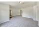 Spacious living room with neutral paint, and seamless transitions to the kitchen and other areas at 131 Pecan Pass, Ocala, FL 34472