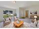 Bright living room features neutral tones, natural light, and comfortable seating arrangement at 131 Pecan Pass, Ocala, FL 34472