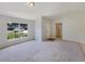 Bright living room featuring neutral paint, carpet, and a large window at 131 Pecan Pass, Ocala, FL 34472
