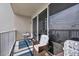 Balcony featuring wicker chairs and table with a blue rug at 13415 Blue Heron Beach Dr # 409, Orlando, FL 32821