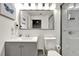 Bathroom featuring a gray vanity, commode, and shower with glass doors at 13415 Blue Heron Beach Dr # 409, Orlando, FL 32821