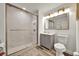 Bathroom with updated vanity and shower with sliding glass door at 13415 Blue Heron Beach Dr # 409, Orlando, FL 32821