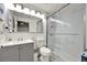 Bathroom featuring a stylish vanity, toilet, and a glass-enclosed shower with marble tile at 13415 Blue Heron Beach Dr # 409, Orlando, FL 32821