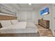 Bedroom with wood flooring, a flat screen TV, a dresser, and a queen bed with white bedding at 13415 Blue Heron Beach Dr # 409, Orlando, FL 32821