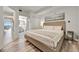 Bedroom featuring a queen-sized bed, wood flooring, ensuite bathroom, and view to the living area at 13415 Blue Heron Beach Dr # 409, Orlando, FL 32821