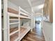 Hallway with wooden floors, a bunk bed, and a view into the living room and balcony overlooking the water at 13415 Blue Heron Beach Dr # 409, Orlando, FL 32821