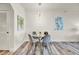 Cozy dining area with a glass table, unique chairs, and a contemporary chandelier at 13415 Blue Heron Beach Dr # 409, Orlando, FL 32821
