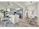 Dining area adjacent to the kitchen featuring a glass table and modern chandelier at 13415 Blue Heron Beach Dr # 409, Orlando, FL 32821