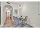Dining area featuring a glass table, stylish chairs, and modern lighting fixture at 13415 Blue Heron Beach Dr # 409, Orlando, FL 32821