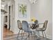 Cozy dining area featuring a round glass table, four modern chairs, and stylish lighting at 13415 Blue Heron Beach Dr # 409, Orlando, FL 32821